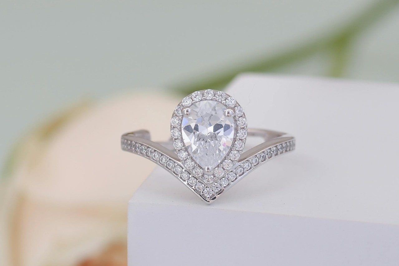a halo engagement ring with channel sidestone setting