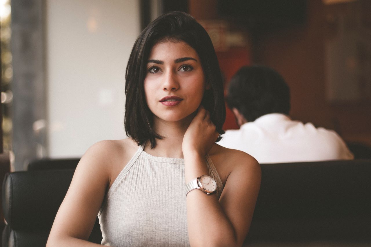 A young woman wearing a simple yet elegant luxury watch.