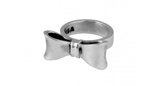 a white gold fashion ring with a sculpted bow motif