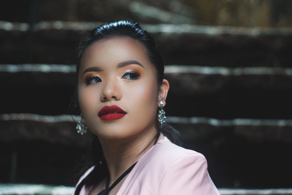 A trendy young woman wearing gorgeous diamond earrings.